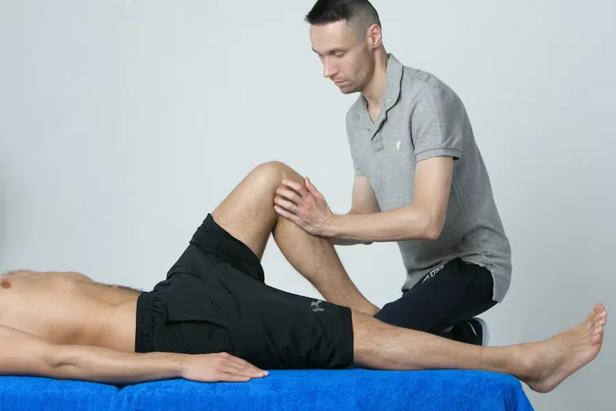 A physical therapist working with a patient's leg during a session